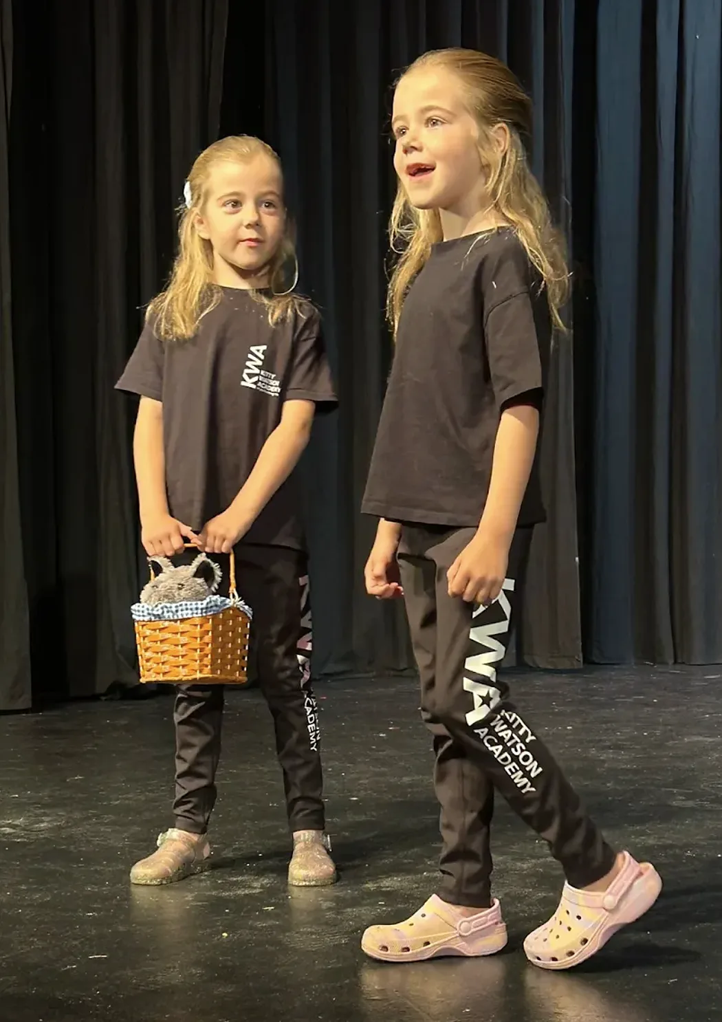 Two young KWA students performing a scene on stage