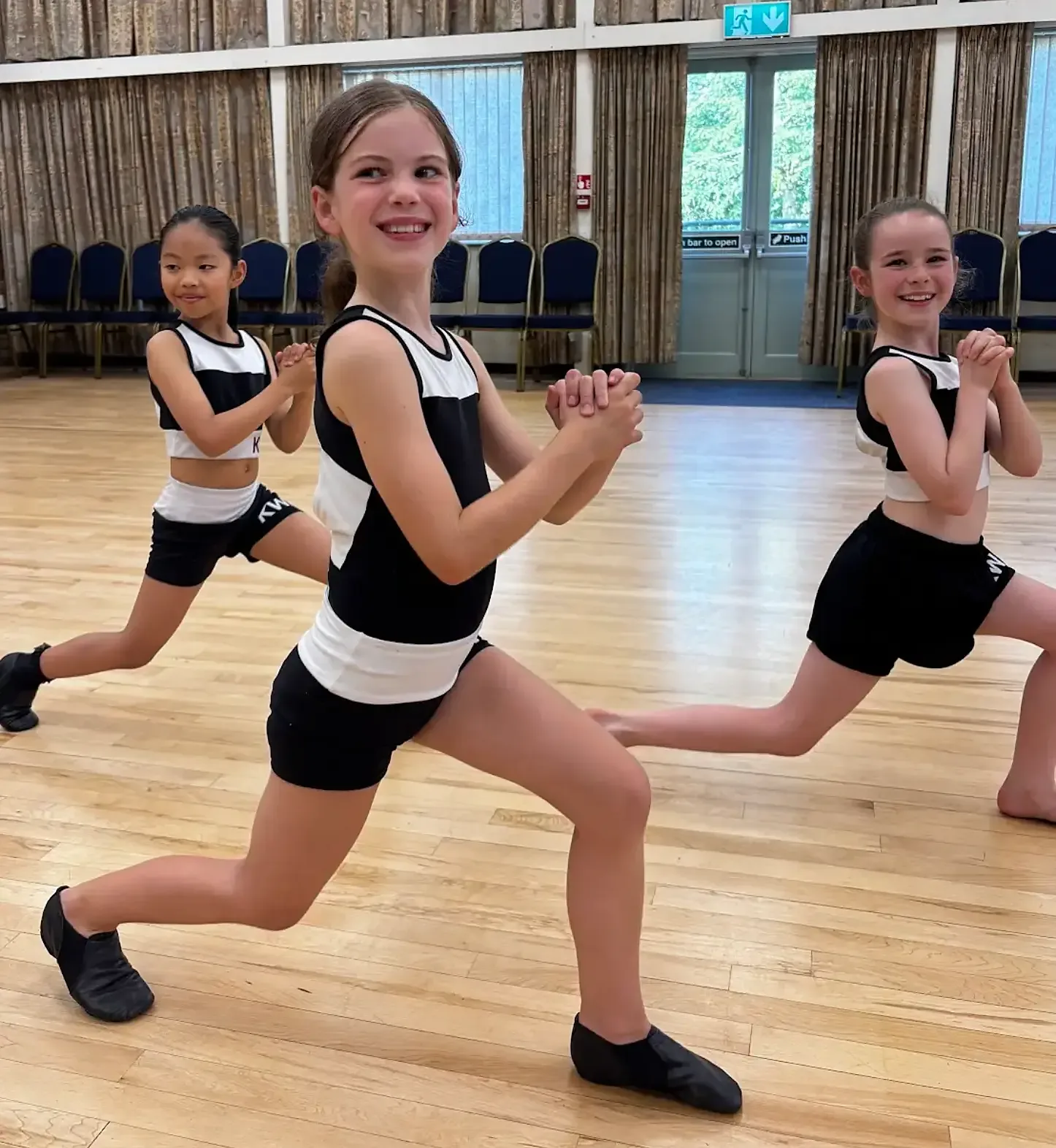 Students in KWA kit holding a lunge in a modern dance class
