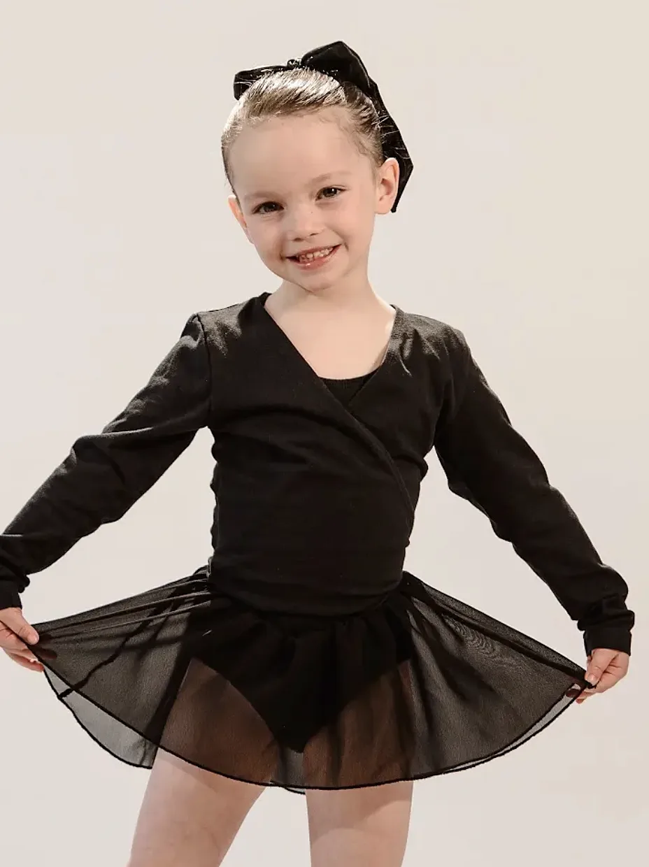 Young ballet dancer in a black wrap top and skirt